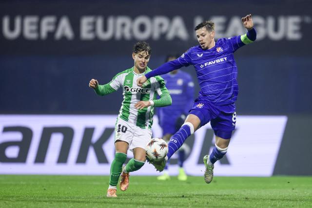(251212) -- ZAGREB, Dec. 12, 2025 (Xinhua) -- Angel Ortiz (L) of Real Betis and Miha Zajc of Dinamo compete for the ball during the UEFA Europa League 2025/26 League Phase match between GNK Dinamo and Real Betis in Zagreb, Croatia, on Dec. 11, 2025. (Sanjin Strukic/PIXSELL via Xinhua)