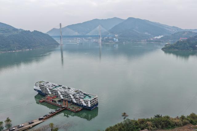 (251212) -- BEIJING, Dec. 12, 2025 (Xinhua) -- A drone photo taken on Dec. 5, 2025 shows export-bound new energy vehicles being loaded onto a shipping vessel at a dock in Chongqing, southwest China. In recent years, as Chongqing accelerated its transformation into an inland hub for opening-up, a growing number of locally manufactured vehicles have found their way to overseas markets. 
According to the Chongqing Customs, in the first ten months of 2025, the export value of Chongqing-manufactured vehicles increased 13.6 percent year on year. (Xinhua/Huang Wei)