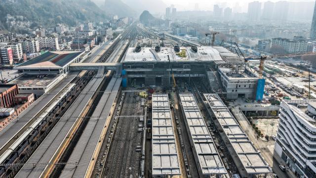 (251212) -- BEIJING, Dec. 12, 2025 (Xinhua) -- An aerial drone photo taken on Dec. 11, 2025 shows a construction site of the Liupanshui Railway Station building and yard renovation project in Liupanshui City, southwest China's Guizhou Province. The renovation project of the station building and yard of Liupanshui Railway Station on the Anshun-Liupanshui High-Speed Railway is advancing steadily at present. (Xinhua/Tao Liang)