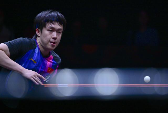 (251212) -- HONG KONG, Dec. 12, 2025 (Xinhua) -- Wang Chuqin of China hits a return during the men's singles quarterfinal match against Alexis Lebrun of France at the WTT Finals Hong Kong 2025 in Hong Kong, south China, Dec. 12, 2025. (Xinhua/Chen Duo)