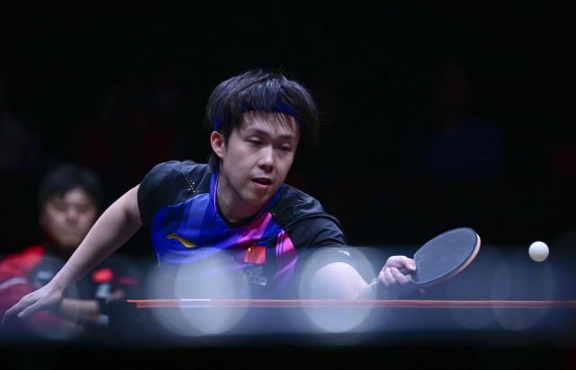 (251212) -- HONG KONG, Dec. 12, 2025 (Xinhua) -- Wang Chuqin of China hits a return during the men's singles quarterfinal match against Alexis Lebrun of France at the WTT Finals Hong Kong 2025 in Hong Kong, south China, Dec. 12, 2025. (Xinhua/Chen Duo)
