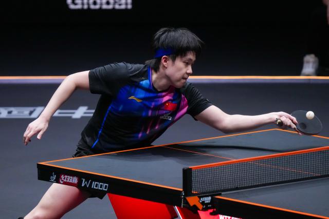 (251212) -- HONG KONG, Dec. 12, 2025 (Xinhua) -- Wang Chuqin of China hits a return during the men's singles quarterfinal match against Alexis Lebrun of France at the WTT Finals Hong Kong 2025 in Hong Kong, south China, Dec. 12, 2025. (Xinhua/Zhu Wei)
