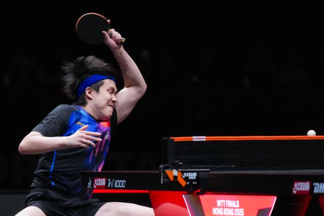 (251212) -- HONG KONG, Dec. 12, 2025 (Xinhua) -- Wang Chuqin of China hits a return during the men's singles quarterfinal match against Alexis Lebrun of France at the WTT Finals Hong Kong 2025 in Hong Kong, south China, Dec. 12, 2025. (Xinhua/Zhu Wei)