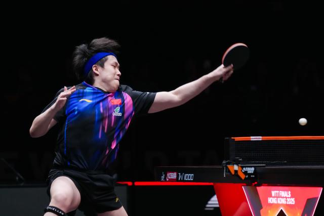 (251212) -- HONG KONG, Dec. 12, 2025 (Xinhua) -- Wang Chuqin of China hits a return during the men's singles quarterfinal match against Alexis Lebrun of France at the WTT Finals Hong Kong 2025 in Hong Kong, south China, Dec. 12, 2025. (Xinhua/Zhu Wei)