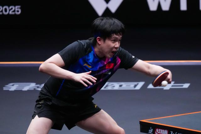 (251212) -- HONG KONG, Dec. 12, 2025 (Xinhua) -- Wang Chuqin of China hits a return during the men's singles quarterfinal match against Alexis Lebrun of France at the WTT Finals Hong Kong 2025 in Hong Kong, south China, Dec. 12, 2025. (Xinhua/Zhu Wei)