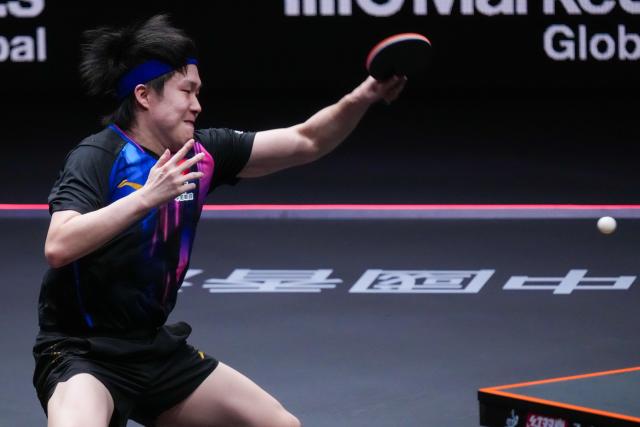 (251212) -- HONG KONG, Dec. 12, 2025 (Xinhua) -- Wang Chuqin of China hits a return during the men's singles quarterfinal match against Alexis Lebrun of France at the WTT Finals Hong Kong 2025 in Hong Kong, south China, Dec. 12, 2025. (Xinhua/Zhu Wei)
