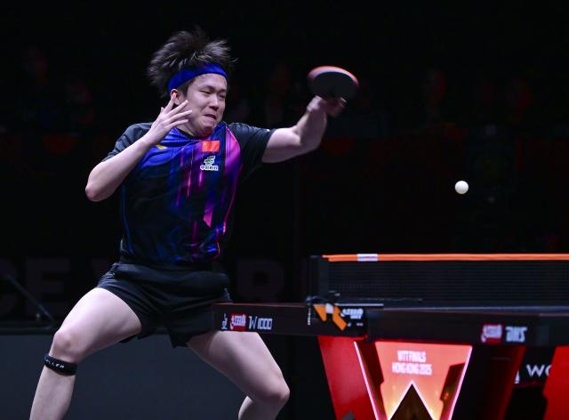 (251212) -- HONG KONG, Dec. 12, 2025 (Xinhua) -- Wang Chuqin of China hits a return during the men's singles quarterfinal match against Alexis Lebrun of France at the WTT Finals Hong Kong 2025 in Hong Kong, south China, Dec. 12, 2025. (Xinhua/Chen Duo)