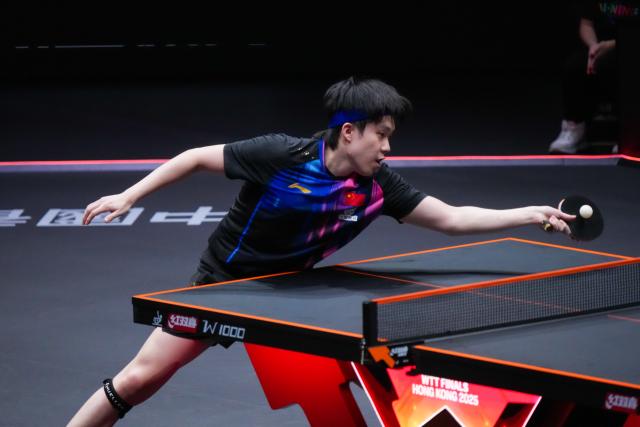 (251212) -- HONG KONG, Dec. 12, 2025 (Xinhua) -- Wang Chuqin of China hits a return during the men's singles quarterfinal match against Alexis Lebrun of France at the WTT Finals Hong Kong 2025 in Hong Kong, south China, Dec. 12, 2025. (Xinhua/Zhu Wei)