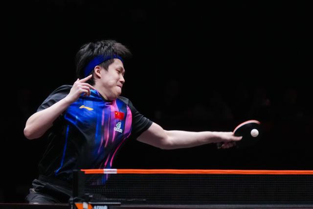 (251212) -- HONG KONG, Dec. 12, 2025 (Xinhua) -- Wang Chuqin of China hits a return during the men's singles quarterfinal match against Alexis Lebrun of France at the WTT Finals Hong Kong 2025 in Hong Kong, south China, Dec. 12, 2025. (Xinhua/Zhu Wei)