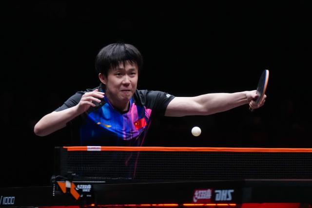 (251212) -- HONG KONG, Dec. 12, 2025 (Xinhua) -- Wang Chuqin of China hits a return during the men's singles quarterfinal match against Alexis Lebrun of France at the WTT Finals Hong Kong 2025 in Hong Kong, south China, Dec. 12, 2025. (Xinhua/Zhu Wei)