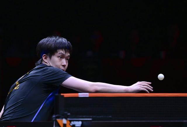 (251212) -- HONG KONG, Dec. 12, 2025 (Xinhua) -- Wang Chuqin of China hits a return during the men's singles quarterfinal match against Alexis Lebrun of France at the WTT Finals Hong Kong 2025 in Hong Kong, south China, Dec. 12, 2025. (Xinhua/Chen Duo)