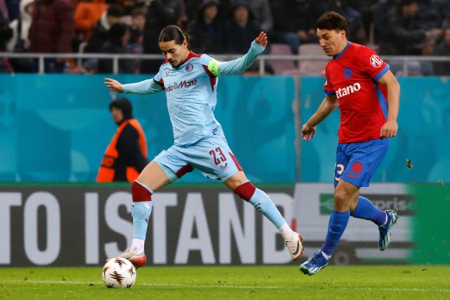 (251212) -- BUCHAREST, Dec. 12, 2025 (Xinhua) -- FCSB's Risto Radunovic (R) vies with Feyenoord's Anis Hadj Moussa during the UEFA Europa League football match between FCSB and Feyenoord in Bucharest, Romania, Dec. 11, 2025. (Photo by Cristian Cristel/Xinhua)