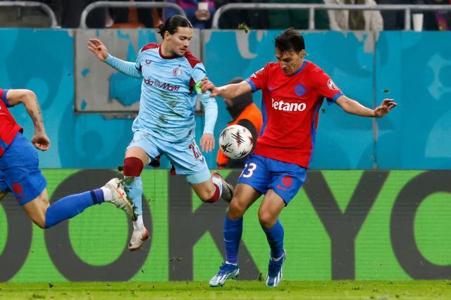 (251212) -- BUCHAREST, Dec. 12, 2025 (Xinhua) -- FCSB's Risto Radunovic (R) vies with Feyenoord's Anis Hadj Moussa during the UEFA Europa League football match between FCSB and Feyenoord in Bucharest, Romania, Dec. 11, 2025. (Photo by Cristian Cristel/Xinhua)