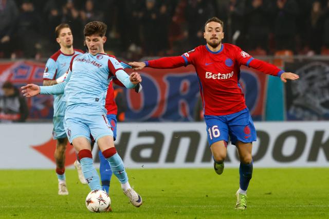 (251212) -- BUCHAREST, Dec. 12, 2025 (Xinhua) -- FCSB's Mihai Lixandru (R) vies with Feyenoord's Jordan Bos (front L) during the UEFA Europa League football match between FCSB and Feyenoord in Bucharest, Romania, Dec. 11, 2025. (Photo by Cristian Cristel/Xinhua)