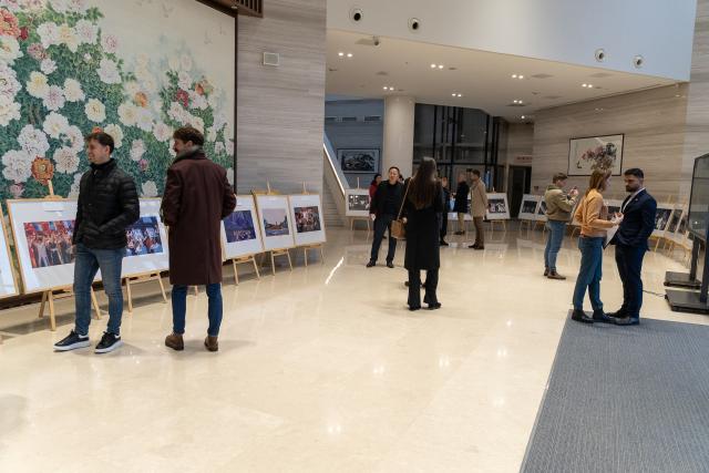 (251212) -- BELGRADE, Dec. 12, 2025 (Xinhua) -- People visit a photo exhibition marking the 70th anniversary of the first China tour by Serbia's National Ensemble "Kolo" at the Chinese Cultural Center in Belgrade, Serbia, Dec. 11, 2025. The exhibition, featuring photographs from Kolo's 1955 and 2025 China tours, opened here on Thursday. (Photo by Nemanja Cabric/Xinhua)