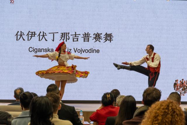 (251212) -- BELGRADE, Dec. 12, 2025 (Xinhua) -- Dancers perform during the opening ceremony of a photo exhibition marking the 70th anniversary of the first China tour by Serbia's National Ensemble "Kolo" at the Chinese Cultural Center in Belgrade, Serbia, Dec. 11, 2025. The exhibition, featuring photographs from Kolo's 1955 and 2025 China tours, opened here on Thursday. (Photo by Nemanja Cabric/Xinhua)