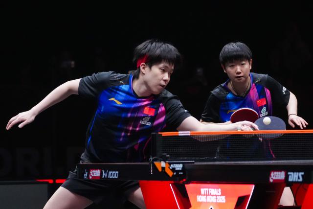 (251212) -- HONG KONG, Dec. 12, 2025 (Xinhua) -- Wang Chuqin (L)/Sun Yingsha compete during the mixed doubles group 1 match between Wang Chuqin/Sun Yingsha of China and Wong Chun Ting/Doo Hoi Kem of China's Hong Kong at the WTT Finals Hong Kong 2025 in Hong Kong, south China, Dec. 12, 2025. (Xinhua/Zhu Wei)