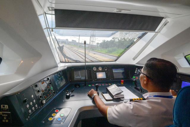 (251212) -- KUALA LUMPUR, Dec. 12, 2025 (Xinhua) -- This photo taken on Dec. 11, 2025 shows a driver inside a train running on Malaysia's new double-tracked electrified rail line between Gemas and Johor Bahru. TO GO WITH "Feature: Malaysia launches new electrified train line connecting southern states" (Photo by Chong Voon Chung/Xinhua)