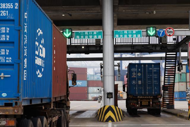 (251212) -- HAIKOU, Dec. 12, 2025 (Xinhua) -- Trucks go through stress test rehearsals at Yangpu International Container Terminal in Danzhou, south China's Hainan Province, Dec. 11, 2025. The Hainan Free Trade Port is preparing for island-wide special customs operations starting Dec. 18., a major milestone in the opening-up drive of the world's second-largest economy despite rising protectionism worldwide. (Xinhua/Jin Liwang)