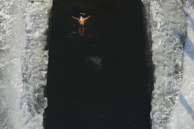 (251213) -- BEIJING, Dec. 13, 2025 (Xinhua) -- An aerial drone photo taken on Dec. 12, 2025 shows a man swimming in icy water at a park in Harbin, northeast China's Heilongjiang Province. (Xinhua/Zhang Tao)