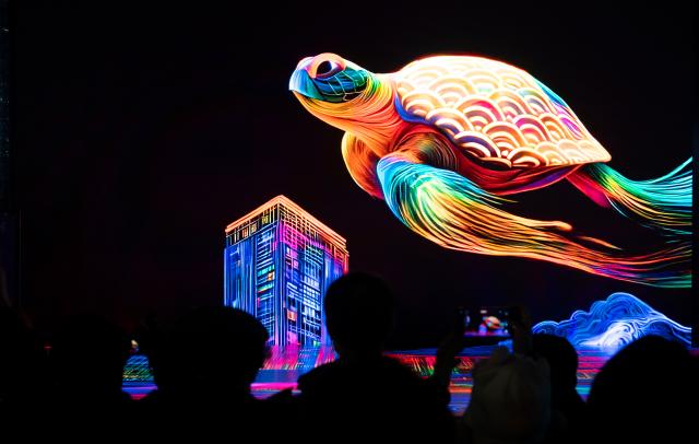(251213) -- BEIJING, Dec. 13, 2025 (Xinhua) -- People view light installations of the 2025 Seoul Winter Festa at the Gwanghwamun Square in Seoul, South Korea, Dec. 12, 2025. (Photo by Jun Hyosang/Xinhua)