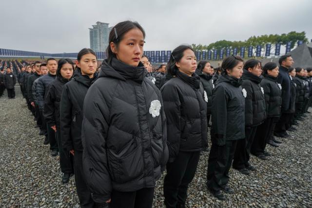(251213) -- NANJING, Dec. 13, 2025 (Xinhua) -- A national memorial ceremony for the Nanjing Massacre victims is held at the Memorial Hall of the Victims in Nanjing Massacre by Japanese Invaders in Nanjing, capital of east China's Jiangsu Province, Dec. 13, 2025. The 12th national memorial day was observed in Nanjing on Saturday to honor about 300,000 victims killed by Japanese troops during the Nanjing Massacre, in a year that marks the 80th anniversary of the end of World War II (WWII). (Xinhua/Li Bo)