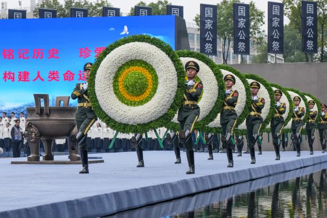 (251213) -- NANJING, Dec. 13, 2025 (Xinhua) -- A national memorial ceremony for the Nanjing Massacre victims is held at the Memorial Hall of the Victims in Nanjing Massacre by Japanese Invaders in Nanjing, capital of east China's Jiangsu Province, Dec. 13, 2025. The 12th national memorial day was observed in Nanjing on Saturday to honor about 300,000 victims killed by Japanese troops during the Nanjing Massacre, in a year that marks the 80th anniversary of the end of World War II (WWII). (Xinhua/Li Bo)