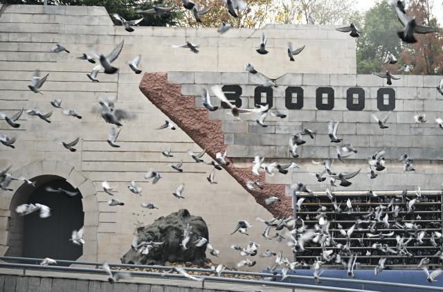 (251213) -- NANJING, Dec. 13, 2025 (Xinhua) -- Doves are released during a national memorial ceremony for the Nanjing Massacre victims held at the Memorial Hall of the Victims in Nanjing Massacre by Japanese Invaders in Nanjing, capital of east China's Jiangsu Province, Dec. 13, 2025. The 12th national memorial day was observed in Nanjing on Saturday to honor about 300,000 victims killed by Japanese troops during the Nanjing Massacre, in a year that marks the 80th anniversary of the end of World War II (WWII). (Xinhua/Li Xiang)