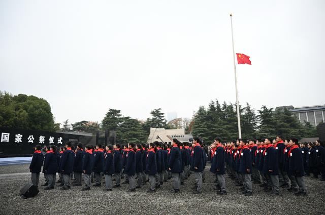 (251213) -- NANJING, Dec. 13, 2025 (Xinhua) -- A national memorial ceremony for the Nanjing Massacre victims is held at the Memorial Hall of the Victims in Nanjing Massacre by Japanese Invaders in Nanjing, capital of east China's Jiangsu Province, Dec. 13, 2025. The 12th national memorial day was observed in Nanjing on Saturday to honor about 300,000 victims killed by Japanese troops during the Nanjing Massacre, in a year that marks the 80th anniversary of the end of World War II (WWII). (Xinhua/Li Xiang)