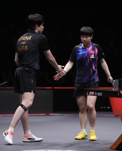 (251213) -- HONG KONG, Dec. 13, 2025 (Xinhua) -- Wang Chuqin/Sun Yingsha (R) of China celebrate during the mixed doubles quarterfianl match between Wang Chuqin/Sun Yingsha of China and Matsushima Sora/Harimoto Miwa of Japan at the WTT Finals Hong Kong 2025 in Hong Kong, south China, Dec. 13, 2025. (Xinhua/Lui Siu Wai)