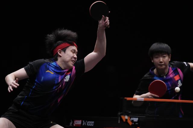 (251213) -- HONG KONG, Dec. 13, 2025 (Xinhua) -- Wang Chuqin (L)/Sun Yingsha of China compete during the mixed doubles quarterfianl match between Wang Chuqin/Sun Yingsha of China and Matsushima Sora/Harimoto Miwa of Japan at the WTT Finals Hong Kong 2025 in Hong Kong, south China, Dec. 13, 2025. (Xinhua/Lui Siu Wai)