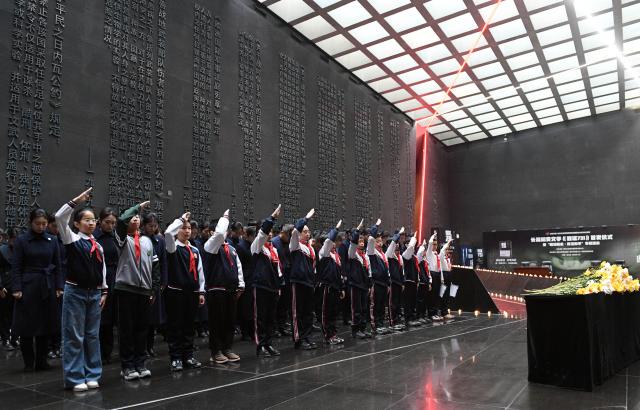 (251213) -- BEIJING, Dec. 13, 2025 (Xinhua) -- A memorial ceremony for the Nanjing Massacre victims is held at the Exhibition Hall of Evidence of Crimes Committed by Unit 731 of the Japanese Imperial Army in Harbin, capital of northeast China's Heilongjiang Province, Dec. 13, 2025. The 12th national memorial day was observed on Saturday across the country to honor about 300,000 victims killed by Japanese troops during the Nanjing Massacre, in a year that marks the 80th anniversary of the end of World War II (WWII). (Photo by Liu Yang/Xinhua)