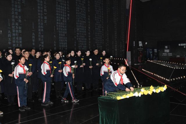 (251213) -- BEIJING, Dec. 13, 2025 (Xinhua) -- A memorial ceremony for the Nanjing Massacre victims is held at the Exhibition Hall of Evidence of Crimes Committed by Unit 731 of the Japanese Imperial Army in Harbin, capital of northeast China's Heilongjiang Province, Dec. 13, 2025. The 12th national memorial day was observed on Saturday across the country to honor about 300,000 victims killed by Japanese troops during the Nanjing Massacre, in a year that marks the 80th anniversary of the end of World War II (WWII). (Photo by Liu Yang/Xinhua)