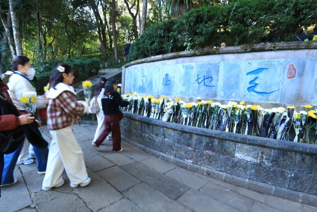 (251213) -- BEIJING, Dec. 13, 2025 (Xinhua) -- People pay tributes to martyrs at a monument of a memorial hall for the Chinese People's War of Resistance against Japanese Aggression in western Yunnan, in Tengchong, southwest China's Yunnan Province, Dec. 13, 2025. The 12th national memorial day was observed on Saturday across the country to honor about 300,000 victims killed by Japanese troops during the Nanjing Massacre, in a year that marks the 80th anniversary of the end of World War II (WWII). (Photo by Gong Zujin/Xinhua)