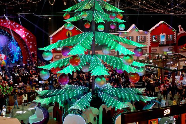 (251213) -- BEIRUT, Dec. 13, 2025 (Xinhua) -- This photo taken on Dec. 12, 2025 shows people enjoying the Christmas atmosphere at a Christmas fair in Beirut, Lebanon. The Christmas fair, or the 13th session of the annual "Christmas In Action," runs from Dec. 12 to Dec. 23. (Photo by Bilal Jawich/Xinhua)