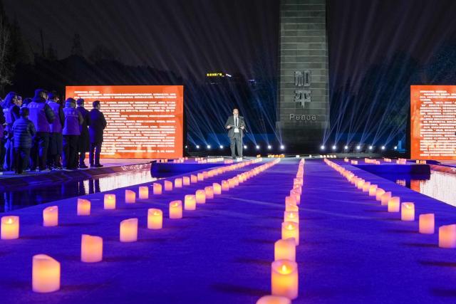 (251213) -- NANJING, Dec. 13, 2025 (Xinhua) -- Christoph Reinhardt, the great-grandson of John Rabe, a German remembered for protecting hundreds of thousands of Chinese civilians during the Nanjing Massacre in 1937, speaks during a candle-light vigil at the Memorial Hall of the Victims in Nanjing Massacre by Japanese Invaders in Nanjing, capital of east China's Jiangsu Province, Dec. 13, 2025. A candle-light vigil was held at the memorial hall on Saturday, which was the 12th national memorial day for the victims of the Nanjing Massacre. (Xinhua/Li Bo)