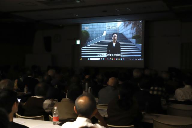 (251213) -- TOKYO, Dec. 13, 2025 (Xinhua) -- Cao Yuli, daughter of two Nanjing Massacre survivors, speaks in a video testimony during a testimony meeting on the Nanjing Massacre in Tokyo, Japan, Dec. 11, 2025. TO GO WITH "Feature: Nanjing Massacre survivors' testimonies renew calls in Japan to confront aggression history" (Xinhua/Li Ziyue)