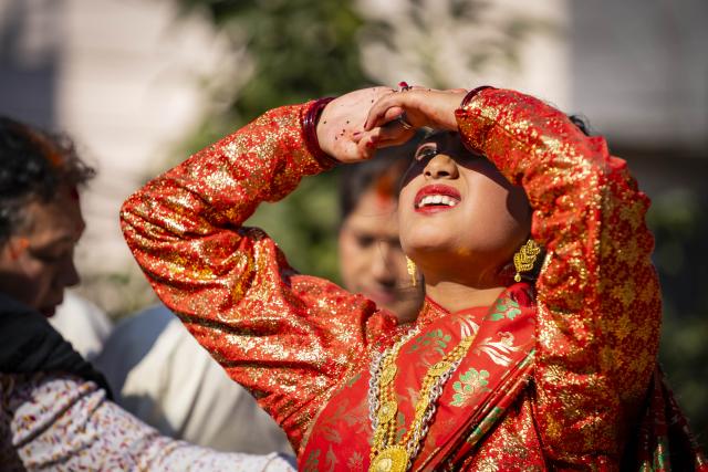 (251213) -- LALITPUR, Dec. 13, 2025 (Xinhua) -- A girl worships the Sun during a puberty ceremony known as Gufa in Lalitpur, Nepal, on Dec. 13, 2025. (Photo by Hari Maharjan/Xinhua)