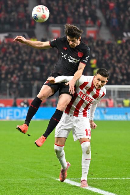 (251214) -- LEVERKUSEN, Dec. 14, 2025 (Xinhua) -- Jonas Hofmann (L) of Bayer 04 Leverkusen vies with Said El Mala of FC Cologne during the German first division of Bundesliga football match between Bayer 04 Leverkusen and FC Cologne in Leverkusen, Germany, Dec. 13, 2025. (Photo by Ulrich Hufnagel/Xinhua)