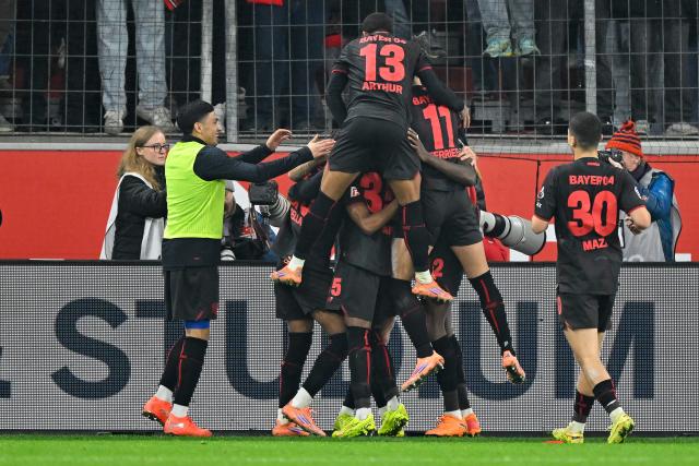 (251214) -- LEVERKUSEN, Dec. 14, 2025 (Xinhua) -- Players of Bayer 04 Leverkusen celebrate scoring during the German first division of Bundesliga football match between Bayer 04 Leverkusen and FC Cologne in Leverkusen, Germany, Dec. 13, 2025. (Photo by Ulrich Hufnagel/Xinhua)