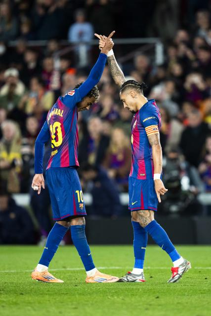 (251214) -- BARCELONA, Dec. 14, 2025 (Xinhua) -- FC Barcelona's Raphinha (R) celebrates his score with teammate Lamine Yamal during the Laliga football match between FC Barcelona and CA Osasuna in Barcelona, Spain, on Dec. 13, 2025. (Photo by Joan Gosa/Xinhua)