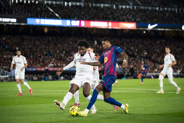 (251214) -- BARCELONA, Dec. 14, 2025 (Xinhua) -- FC Barcelona's Marcus Rashford (front R) vies with CA Osasuna's Enzo Boyomo (front L) during the Laliga football match between FC Barcelona and CA Osasuna in Barcelona, Spain, on Dec. 13, 2025. (Photo by Joan Gosa/Xinhua)