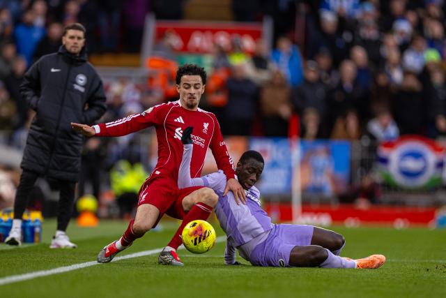 (251214) -- LIVERPOOL, Dec. 14, 2025 (Xinhua) -- Liverpool's Curtis Jones (L) is challenged by Brighton & Hove Albion's Yankuba Minteh during the English Premier League match between Liverpool FC and Brighton & Hove Albion FC in Liverpool, Britain, on Dec. 13, 2025.  
FOR EDITORIAL USE ONLY. NOT FOR SALE FOR MARKETING OR ADVERTISING CAMPAIGNS. NO USE WITH UNAUTHORIZED AUDIO, VIDEO, DATA, FIXTURE LISTS, CLUB/LEAGUE LOGOS OR "LIVE" SERVICES. ONLINE IN-MATCH USE LIMITED TO 45 IMAGES, NO VIDEO EMULATION. NO USE IN BETTING, GAMES OR SINGLE CLUB/LEAGUE/PLAYER PUBLICATIONS. (Xinhua)