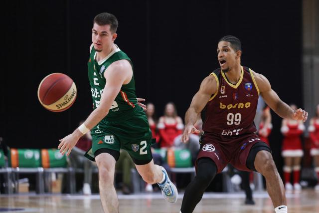 (251214) -- LJUBLJANA, Dec. 14, 2025 (Xinhua) -- Joseph Girard III (L) of Cedevita Olimpija steals the ball during the 10th round match between Cedevita Olimpija and Bosna BH Telekom at the AdmiralBet ABA Basketball League 2025/26 in Ljubljana, Slovenia, Dec. 13, 2025. (Photo by Zeljko Stevanic/Xinhua)