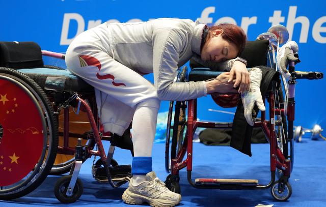 (251214) -- BEIJING, Dec. 14, 2025 (Xinhua) -- Gu Haiyan of Shanghai reacts before the women's sabre individual category A wheelchair fencing match at China's 12th National Games for Persons with Disabilities and the 9th National Special Olympic Games in Hong Kong, south China, Dec. 13, 2025. (Xinhua/Hou Zhaokang)