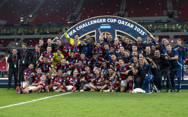 (251214) -- DOHA, Dec. 14, 2025 (Xinhua) -- Players and coach of CR Flamengo celebrate with the trophy after winning the FIFA Challenger Cup 2025 match between Brazil's CR Flamengo and Egypt's Pyramids FC, part of the FIFA Intercontinental Cup 2025 in Doha, Qatar, on Dec. 13, 2025. (Photo by Nikku/Xinhua)
