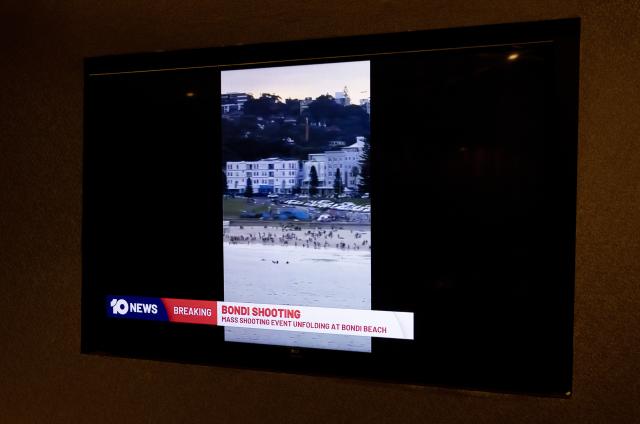(251214) -- SYDNEY, Dec. 14, 2025 (Xinhua) -- This photo taken on Dec. 14, 2025 shows the TV news reporting a mass shooting at Bondi Beach in Sydney, Australia. At least 12 people have died after a shooting at Sydney's Bondi Beach on Sunday night, said New South Wales Premier Chris Minns.
   One of the offenders was among the dead and another one is in custody, the Australian Broadcasting Corporation (ABC) cited Minns as saying. (Xinhua/Ma Ping)