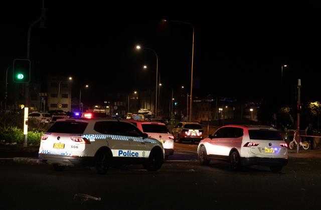 (251214) -- SYDNEY, Dec. 14, 2025 (Xinhua) -- Police vehicles are seen near the shooting site at Bondi Beach in Sydney, Australia, on Dec. 14, 2025. At least 12 people have died after a shooting at Sydney's Bondi Beach on Sunday night, said New South Wales Premier Chris Minns.
   One of the offenders was among the dead and another one is in custody, the Australian Broadcasting Corporation (ABC) cited Minns as saying. (Xinhua/Ma Ping)