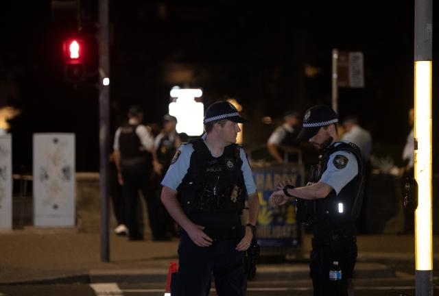 (251214) -- SYDNEY, Dec. 14, 2025 (Xinhua) -- Police officers are seen near the shooting site at Bondi Beach in Sydney, Australia, on Dec. 14, 2025. At least 12 people have died after a shooting at Sydney's Bondi Beach on Sunday night, said New South Wales Premier Chris Minns.
   One of the offenders was among the dead and another one is in custody, the Australian Broadcasting Corporation (ABC) cited Minns as saying. (Xinhua/Ma Ping)