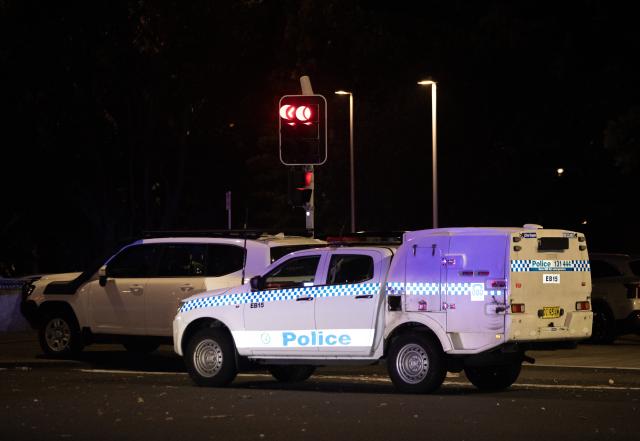 (251214) -- SYDNEY, Dec. 14, 2025 (Xinhua) -- A police vehicle is seen near the shooting site at Bondi Beach in Sydney, Australia, on Dec. 14, 2025. At least 12 people have died after a shooting at Sydney's Bondi Beach on Sunday night, said New South Wales Premier Chris Minns.
   One of the offenders was among the dead and another one is in custody, the Australian Broadcasting Corporation (ABC) cited Minns as saying. (Xinhua/Ma Ping)